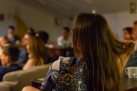 The girl watches live performance of the stand-up show.の写真素材