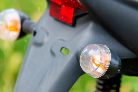 Modern motorcycle turn signal light with blurry backgroundの写真素材