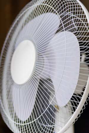 Fragment of electric fan on black background.の写真素材