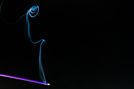 mystery dense blue smoke over dark background, abstract photo.の写真素材