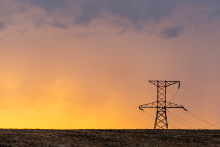 Rural landscape with high-voltage line on sunset. Dramatic sky viewの写真素材