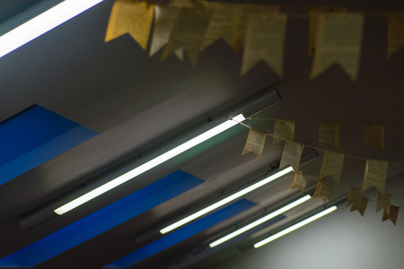 Row of fluorescent lamps of office ceiling