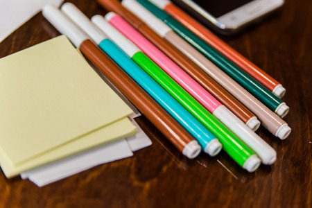 Colorfully Office and art stationery objects on wood table with a notebook.の写真素材