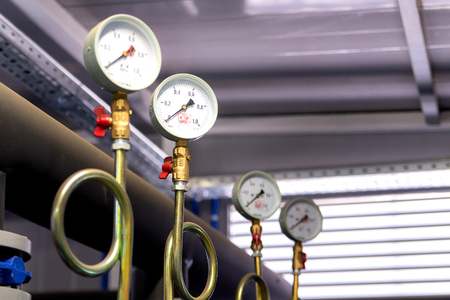 System of hot water pipes with manometer in boiler room.の写真素材