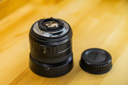 Photo DSLR Camera or Video lens close-up on wooden background, objective, concept of photographer camera man job, looking for a photographer, journalist, a videographer to work.の写真素材