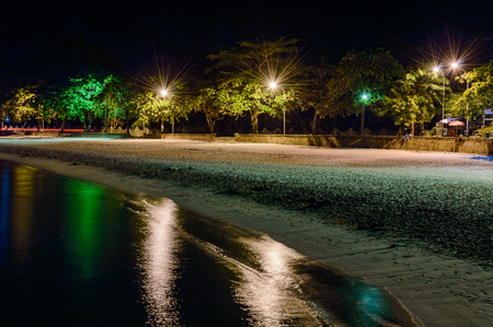 Night sandy beach. View from the sea.の写真素材