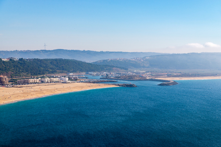 From the high point of the Nazare we can see the beach the sea and the village Nazare, Portugal.の写真素材