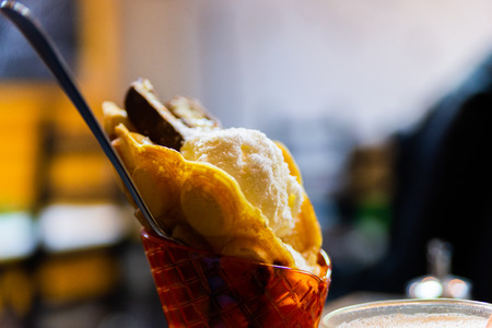 Chocolate and vanilla ice cream in waffle cones.