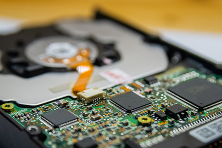 Computer Hard Disk Electronics Circuit, Macro Photo. Hard disk repairing concept, Data saving concept. Blur background with selective focus.の写真素材