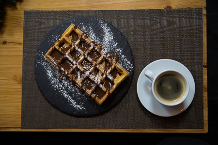 Cup of coffee and Belgian waffles with chocolate.の写真素材