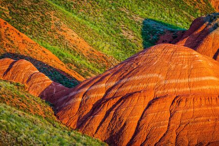 Big Bogdo mountain. Red sandstone outcrops on the slopes sacred mountain in Caspian steppe Bogdo - Baskunchak nature reserve, Astrakhan region, Russiaの写真素材