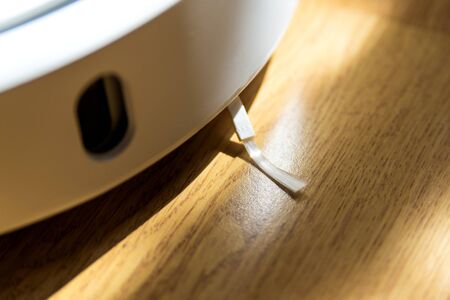 Smart home. Robot vacuum cleaner performs automatic cleaning of the apartment at a certain time....