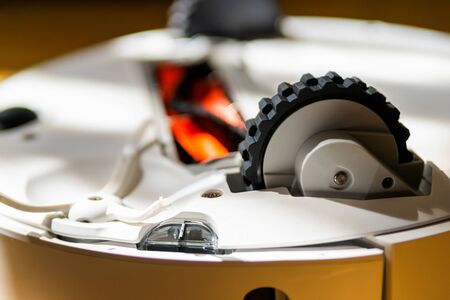Robot vacuum cleaner technical details. View from below. Brushes, wheels and sensors.の写真素材