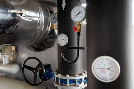 The equipment of the boiler-house, - valves, tubes, pressure gauges, thermometer. Close up of...