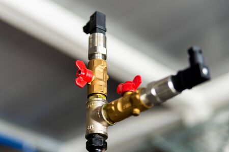 Fittings and valve, pipes and adapters. Plumbing fixtures and piping parts. focus on the red crane.