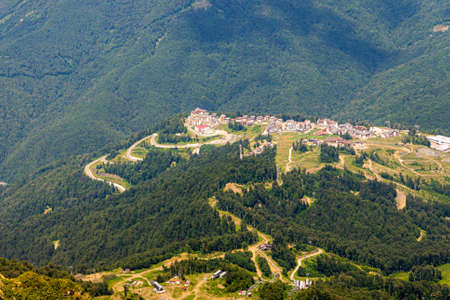 Top view of resort town with hotels on background of mountains. Beautiful landscape of hotels...