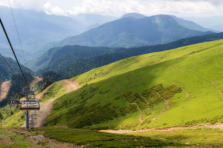 Chairlift in a mountain region in summer. Life of ski resort in summertime.の写真素材