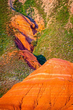 Big Bogdo mountain. Red sandstone outcrops on the slopes sacred mountain in Caspian steppe Bogdo - Baskunchak nature reserve, Astrakhan region, Russiaの写真素材