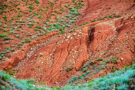 Big Bogdo mountain. Red sandstone outcrops on the slopes sacred mountain in Caspian steppe Bogdo -...