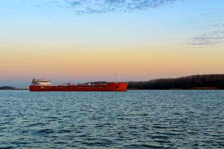 Cargo ship on the river on sunset.の写真素材