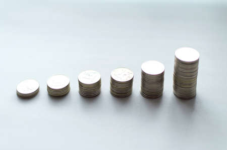 Increasing columns of coins, step of stacks coin isolated on white background with copy space for business and financial concept idea.の写真素材