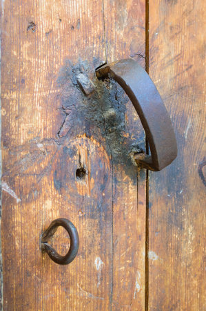 Antique door handle on wooden door in temple.の写真素材