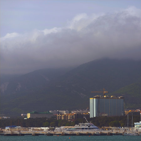 Wonderful view of a small town on the sea coast at the foot of the mountains.の写真素材