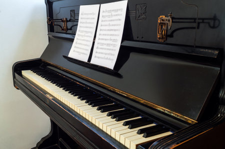 Musical notes on piano keyboard, close up.の写真素材