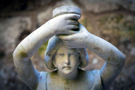 Close up of stone carved woman face of granite sculpture. A close up of a female statue in front of...