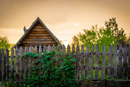 Beautiful ethno house at sunset. Rural house viewの写真素材