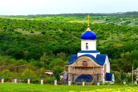 Blue dome of christian church with golden cross. Religious symbol of the Russian Orthodox Church.の写真素材