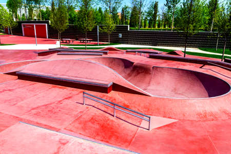 Red skate, roller and bike park with tubes, springboard and jumps.の写真素材
