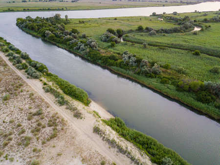 The junction of the river and canal with sandy shores.