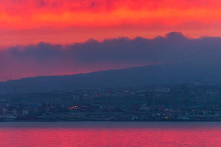 Seascape. Sun in the clouds at sunset over the sea.の写真素材