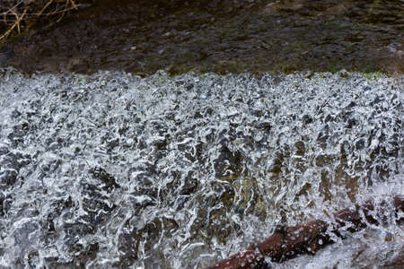 a curtain of water falling over a dam.の写真素材