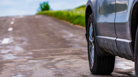 Car by the asphalt road wide and far viewの写真素材