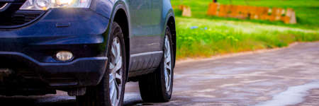 Car by the asphalt road wide and far viewの写真素材