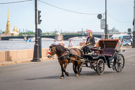 ST PETERSBURG, RUSSIA - JUNE 05, 2021: Carriage for tourists on the treet of Saints Petersburg.