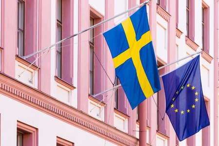 Sweden and euro union flags flags on the wall.の写真素材