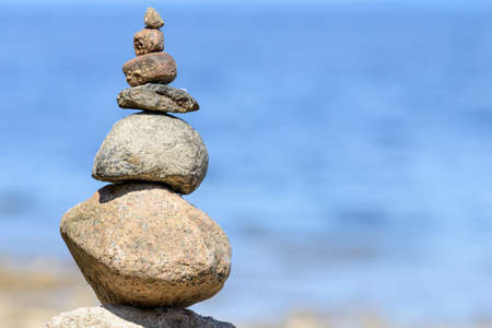 Sea pebbles or stones tower on a beach.の写真素材