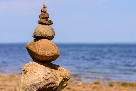 Sea pebbles or stones tower on a beach.の写真素材