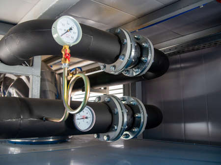 Black rubber expansion joint connecting between 2 piping.