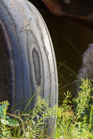 Old worn out truck tire with abrasions and layers of rubber.の写真素材