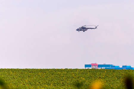 Military helicopter takes off from the field.の写真素材
