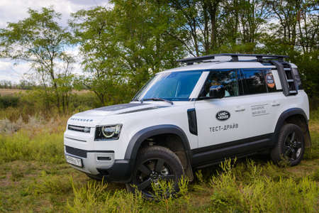 Russia, Rostovskaya oblast, 2021 June 09: Modern new SUV car Land Rover Defender, test drive in a field. Offroad 4x4 driving in wild.のeditorial素材