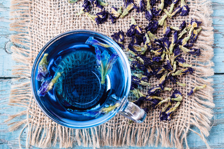 Flower tea of Butterfly pea (pea flowers, blue pea) for healthy drinking, detox drinking on old wooden table top viewの写真素材