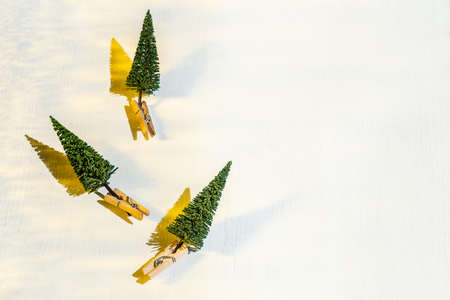 Creative Merry Christmas layout made with fir tree imitation with hard golden shadows on white wooden background with copyspace. Holidays concept, elements of design.の写真素材