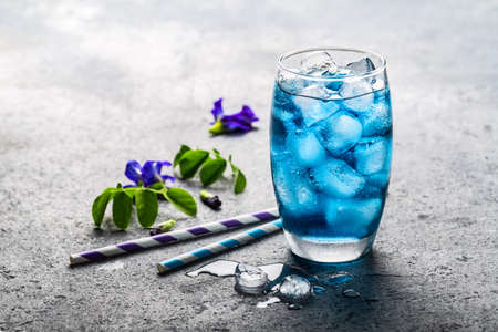 Butterfly pea juice or blue pea flower herbal tea for healthy drinking on gray concrete background.の写真素材