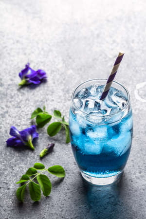 Butterfly pea juice or blue pea flower herbal tea for healthy drinking on gray concrete background.の写真素材