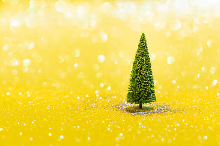 Fir tree on glittering yellow background with copyspace. Happy new year, Merry Christmas, element of...